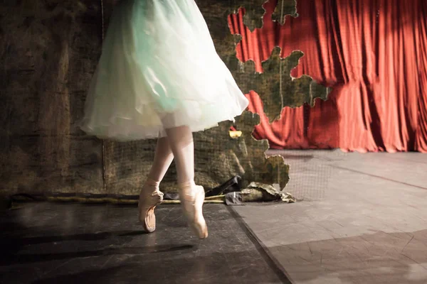 Одежда, профессия, танцы. тонкие ножки невесомости, наполненные воздухом, великолепная балерина в красивом платье, которая танцует и согревается за шторами и украшениями — стоковое фото