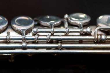 Nefesli/Üflemeli Saz ve senfonik müzik konsepti - yukarı tuşları ile Batı konser flüt vücudunda ve borular siyah arka plan yüzeyi, orta bölümünü en eski ve en yaygın kullanılan pirinç aracı, makro.