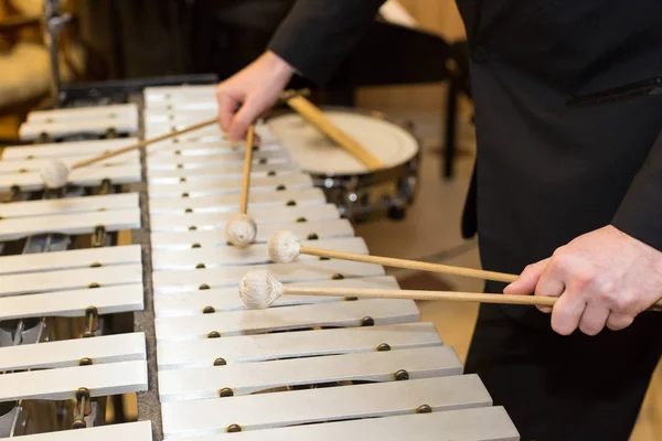 Xylophone in orchestra, playing percussion instruments concept - closeup on wooden bars with four mallets in human hands, performer in black dress, glockenspiel, art of music, selective focus. — Stock Photo, Image