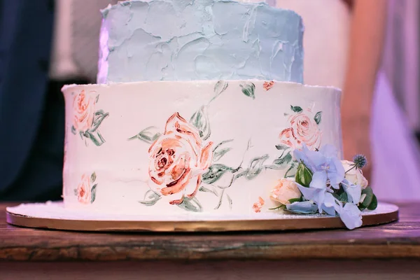 present, decoration, wedding concept. masterpiece of cooking, white and blue engagement cake, made in form of topper and painted with help of food coloring