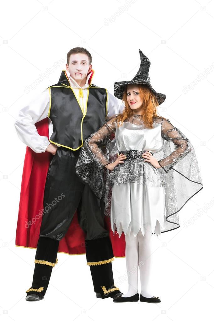all saints day, carnival, celebrating concept. isolated figures, there are vampire and witch in colorful costumes with bright elements. his robe has bloody red lining and her has silver wed