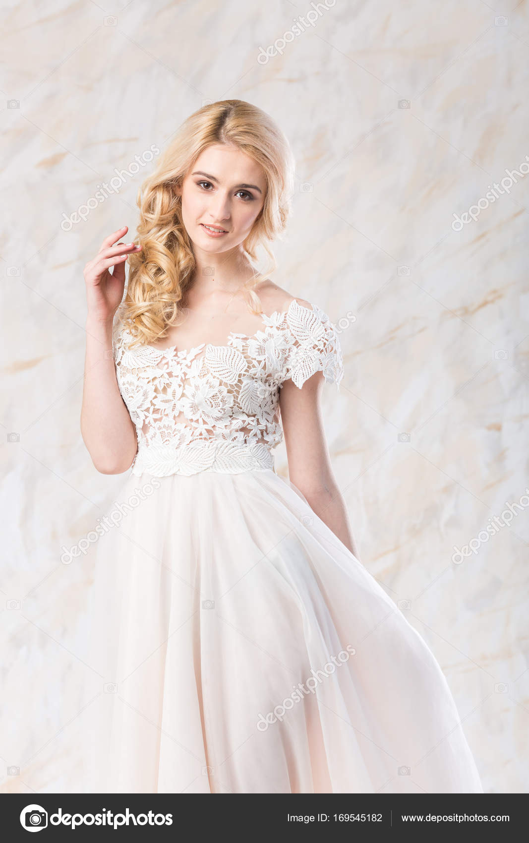 Fashionable Wedding Dress Beautiful Blonde Model Bride Hairstyle And Makeup  Concept Stunning Young Woman In Long Luxury White Gown Indoors On Light  Background Smiling Female Posing In Movement Stock Photo - Download