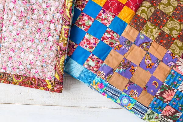 Design, culture, home, comfort, warmth, rest concept - cosy quilts sewed in old russian traditions of cotton patches with different colores and patterns — Stock Photo, Image