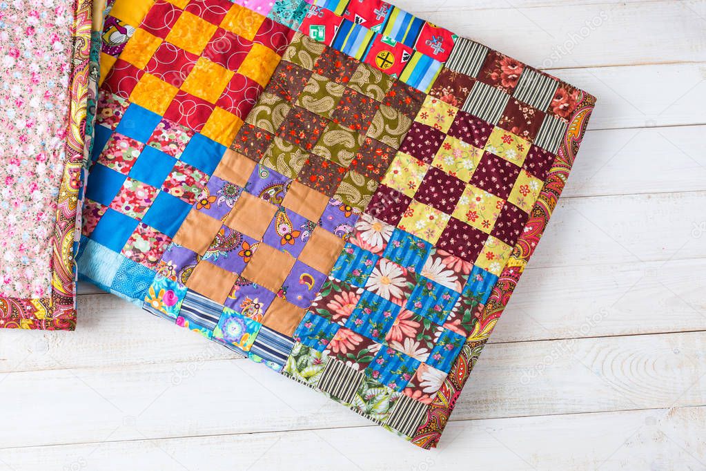 handmade, vintage, interior concept. nice cute little handmade blanket made from different colorful pieces using sewing technique patchwork wildly used in asia