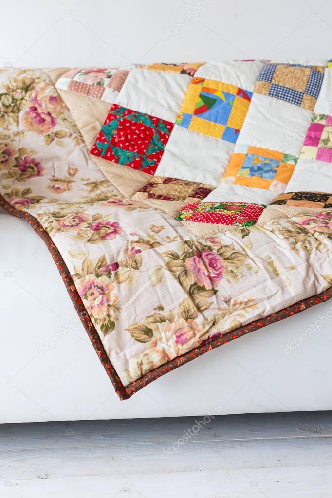 patchwork, ornament, home concept. neat loud-coloured covering with pattern from abstract images and outstanding prints of red roses and white chamomile