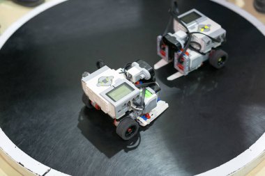 Bilim, mühendislik, teknolojik devrim kavramı. Yeni teknik ekipmanları test etmek için özel platformda karşı karşıya duran iki robotu kapatın.