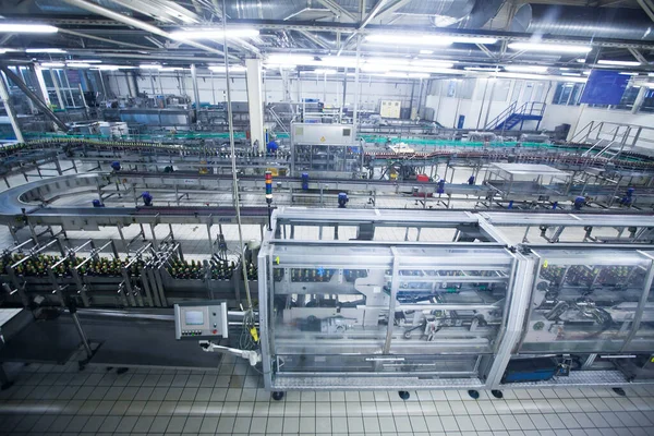 automatic industrial conveyor beverage line. Indoor view of Beer factory.
