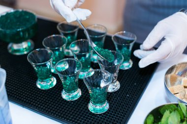 making a green caviar shot at molecular bar drink. clipart