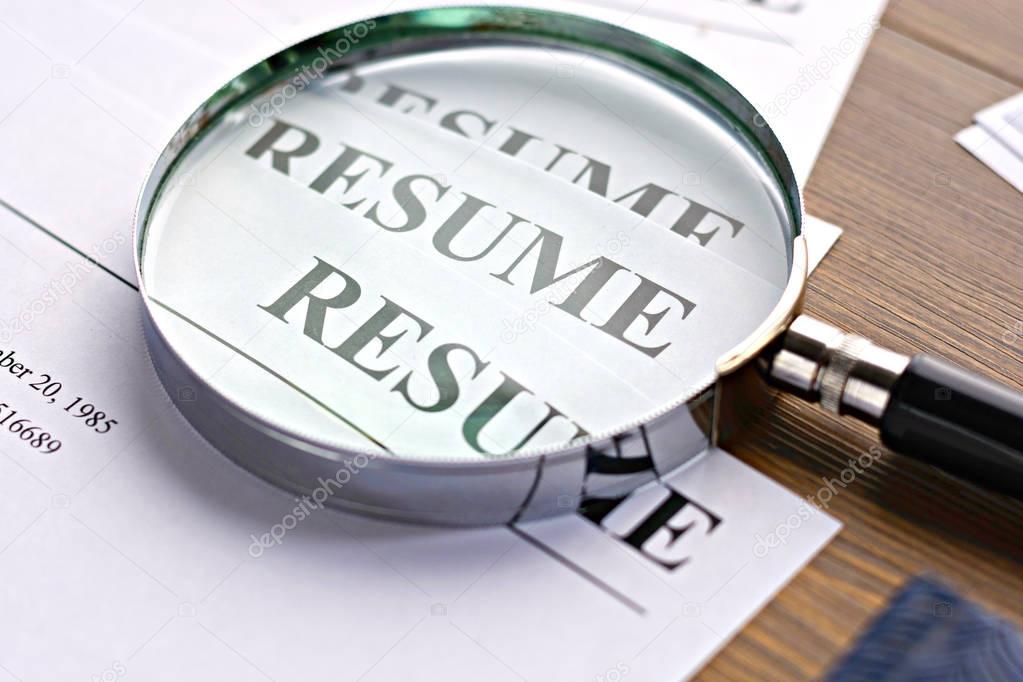 Resume (autobiography), pen, magnifier, laptop on your desktop. job search