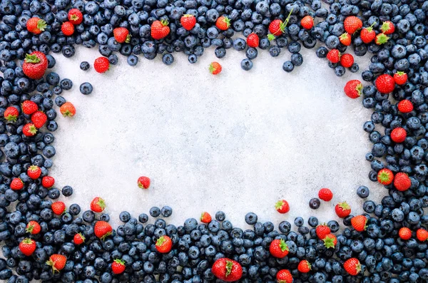 Food frame with mix of strawberry, blueberry. Top view. Vegan and vegetarian concept. Summer berries background