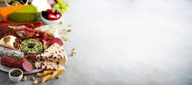 Geleneksel İtalyan meze, kesme füme kurula salam, soğuk et, salam, jambon, peynir, zeytin, Kapari gri arka plan üzerinde. Peynir ve et iştah açıcı. Afiş