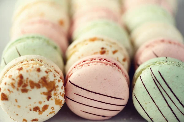 Colorful french macaroons flat lay. Pastel colors pink, green, yellow macarons with copy space, top view. Holidays and celebrations concept. Sweet gift for woman, girl — Stock Photo, Image