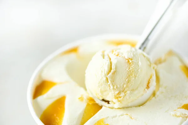 Фон для совок ванильного мороженого. Концепция летнего питания, пространство для копирования, вид сверху. Скрученная текстура. Скупка желтого манго мороженого . — стоковое фото