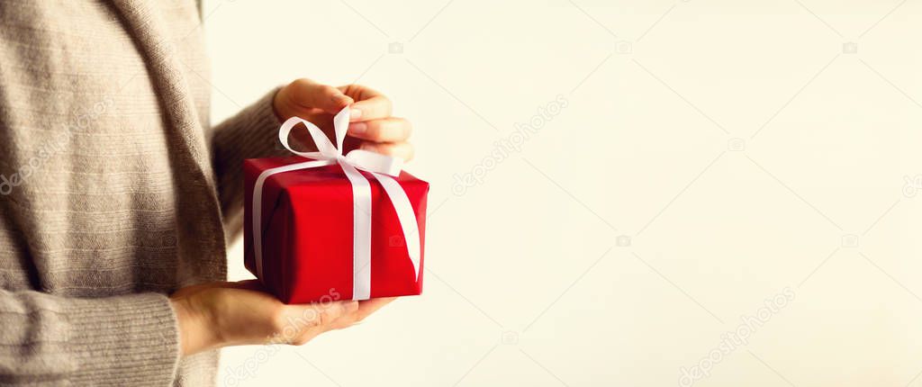 Female hands opening red gift box, copy space. Christmas, new year, birthday party, valentines day, mothers and woman day concept. Present with love. Banner
