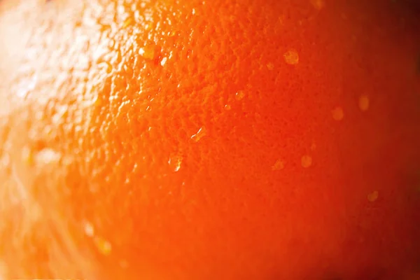 Texture of fresh bright orange peel, closeup, copy space. Macro of orange fruit. Citrus fruit background — Stock Photo, Image