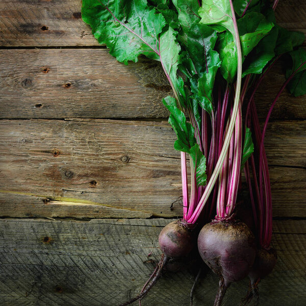 Bunch of fresh organic beetroot on wooden background. Concept of diet, raw, vegetarian meal. Farm, rustic and country style