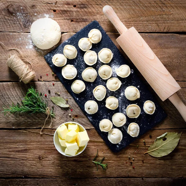 Hazırlamak, pişirmek, ev yapımı ravioli, pelmeni ya da ahşap masa manzaralı etli börek yapmak. Üst Manzara. Kırsal biçim — Stok fotoğraf