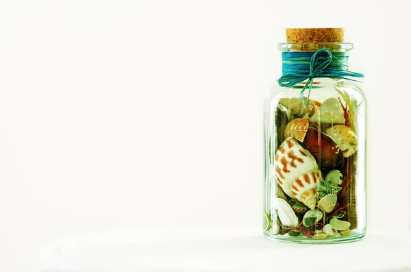 Sand and shells in bottle on white background. Free space for your text — Stock Photo, Image