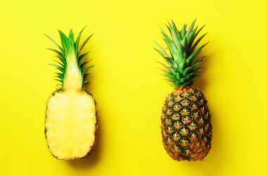 Taze ananas ve meyve Sarı zemin üzerine yarım dilim. Üstten Görünüm. Uzay kopyalayın. Parlak ananas desen en az stil için. Pop sanat tasarım, yaratıcı kavramı