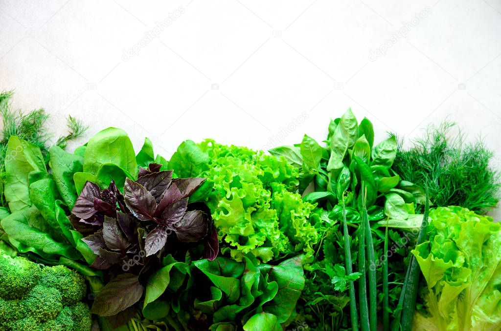 Green fresh aromatic herbs - thyme, basil, parsley on gray background. Food frame, border design. Copyspace. Top view