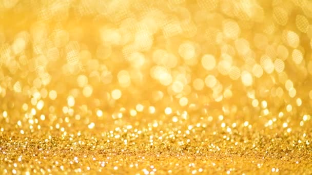 Shiny abstract textured background with golden lights, bokeh. Christmas, new year concept. Festive gold backdrop — 비디오