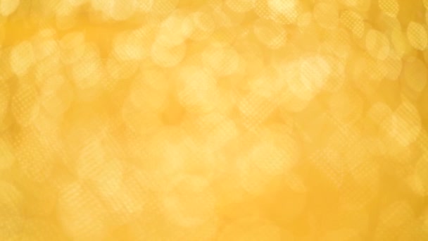 Shiny abstract textured background with golden lights, bokeh. Christmas, new year concept. Festive gold backdrop — 비디오