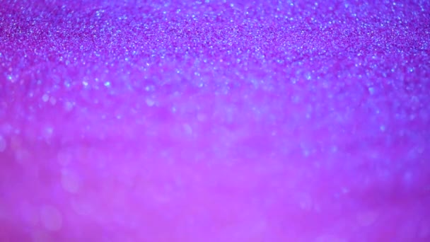 Violette und violette abstrakte Bokeh-Lichter. glänzender Glitzerhintergrund. Neujahrs- und Weihnachtskonzept. rosa funkelnde Grußkarte — Stockvideo