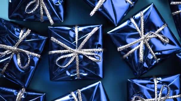 Moving blue gift boxes on blue color background. Christmas and new year rotating backdrop. Present, surprise concept — 비디오