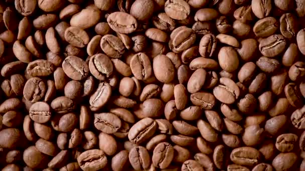 Roasted coffee beans on rorating backgound. Top view. Cappuccino, dark espresso, aroma black caffeine drink, ingredient for coffee beverage. — 비디오