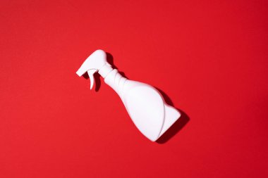 Beyaz plastik temizlik ürünü şişesi, ev kimyasalları ya da kırmızı arka planda sıvı çamaşır deterjanı. Üst Manzara. Düz yatıyordu. Uzayı kopyala Deterjan şişesi.