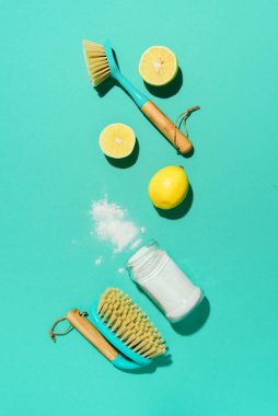 Eco-friendly natural cleaners, cleaning products against chemical detergent bottles. Cleaning tools layout vs backing soda, lemon, mustard powder and bamboo brushes clipart