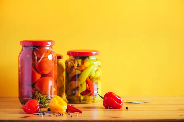 Konserverade grönsaker i glasburkar på orange bakgrund. Uppfattat utrymme. Friska fermenterade livsmedel koncept. Skördebegreppet — Stockfoto