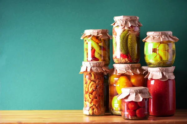 Verduras conservadas en frascos de vidrio sobre fondo verde. Copiar espacio. Concepto de comida fermentada saludable. Concepto de cosecha — Foto de Stock