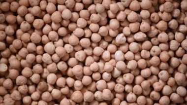 Arkaplanda çiğ organik kurutulmuş nohut dokusu. Vejetaryen sağlıklı beslenme. Üst görünüm, kopyalama alanı, sağlıklı yaşam tarzı konsepti.