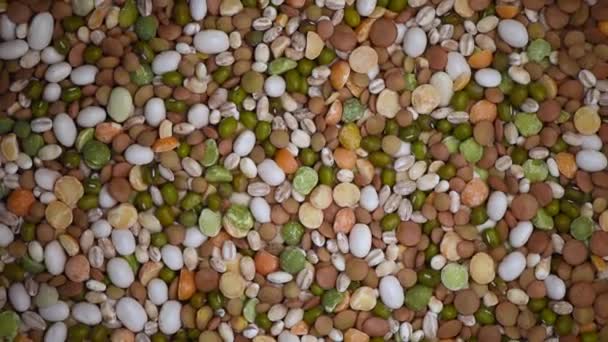 Raw healthy grain food. Beans on rotating background. Grains and seeds texture. Food ingredient background. Top view, healthy lifestyle concept. Vegan healthy nutrition — Stock Video