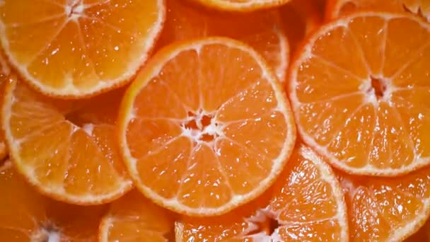 Texture juteuse de mandarine sur fond rotatif. Vue de dessus. Agrumes. Concept alimentaire végétalien et cru. fond d'oranges tranchées — Video