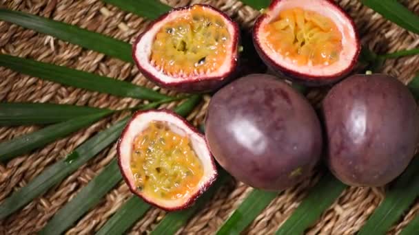 Passionsfrüchte auf rotierendem Hintergrund. Ansicht von oben. Exotische Früchte, tropischer Palmenzweig. Veganes und Rohkost-Konzept. — Stockvideo
