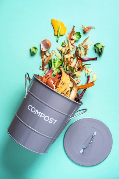 Prullenbak voor compostering met restjes uit de keuken op blauwe achtergrond. Bovenaanzicht. Recycling scarps concept. Duurzame en afvalvrije levensstijl — Stockfoto