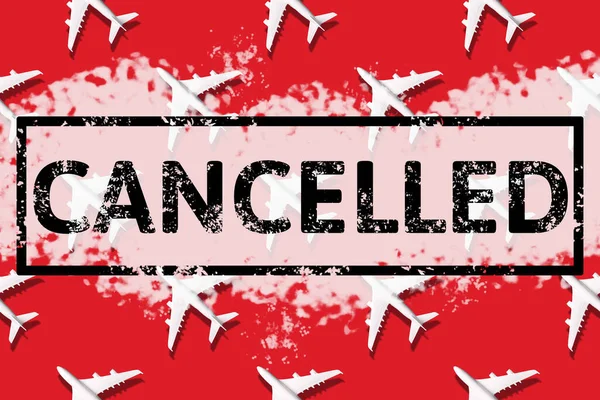 Travel, vacation ban, refund concept. Pattern of white airplanes with text cancelled on red background. Top view. Flight cancellation due to impact of coronavirus COVID-19. Stay home. Airline crisis.