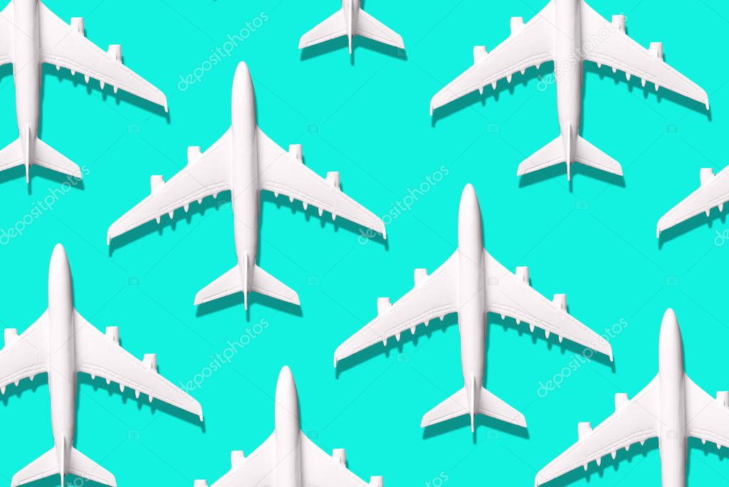 Summer pattern. Creative banner of white planes on blue background. Travel, vacation concept. Travel, vacation ban. Flights cancelled and resumed again. Top view. Flat lay. Minimal style design