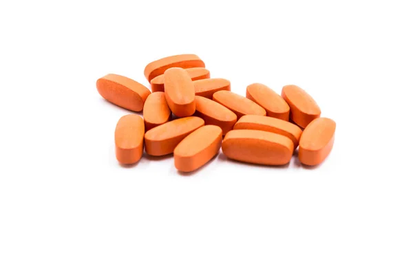Píldoras de color naranja en el fondo blanco — Foto de Stock