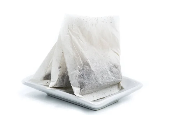 Tea bags in a plate on white — Stock Photo, Image