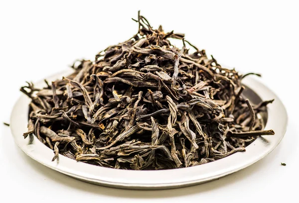 Черный чай листья на тарелке — стоковое фото