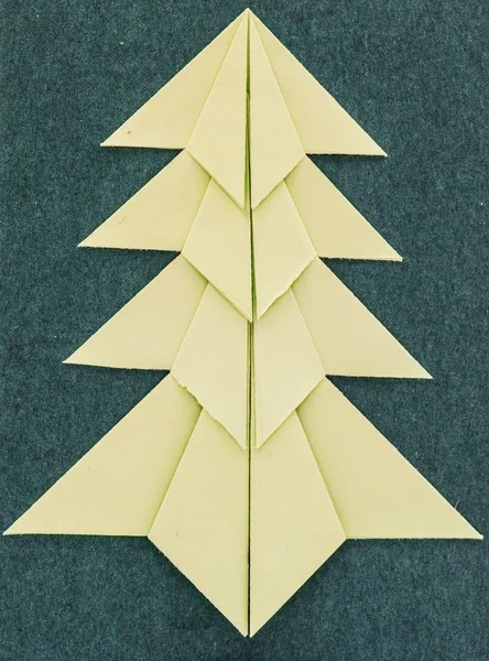 Christmas tree white isolated origami on dark background