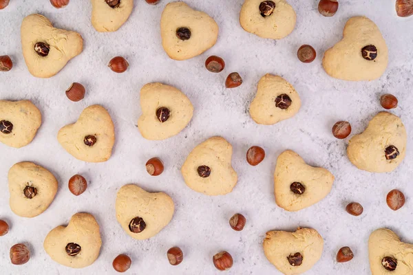 Heart shaped homemade cookies and nuts pattern top view flat lay — Stock Photo, Image