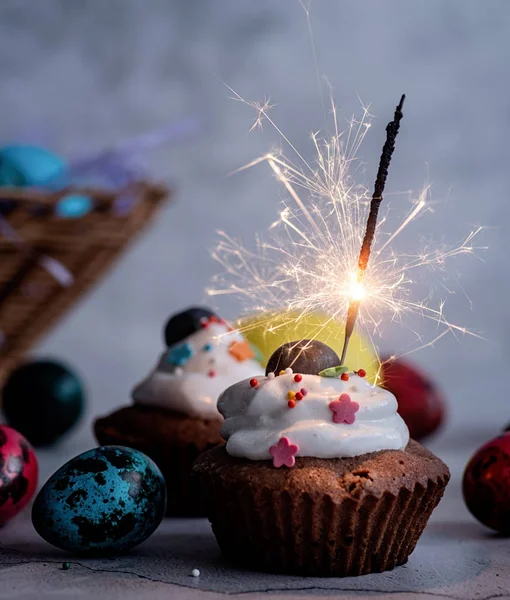 Easter cupcake with a sparkler decorated with colored quail eggs