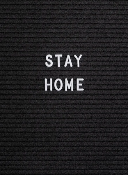 Coronavirus and stay at home order. The words Stay Home on the black felt letter board