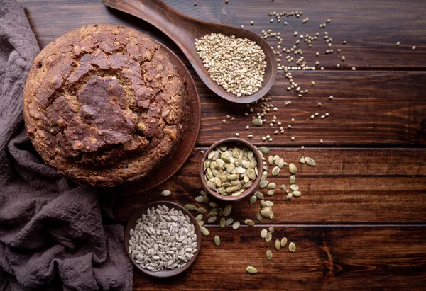 Homemade loaf of buckwheat bread top view on wooden background — Stock Photo, Image