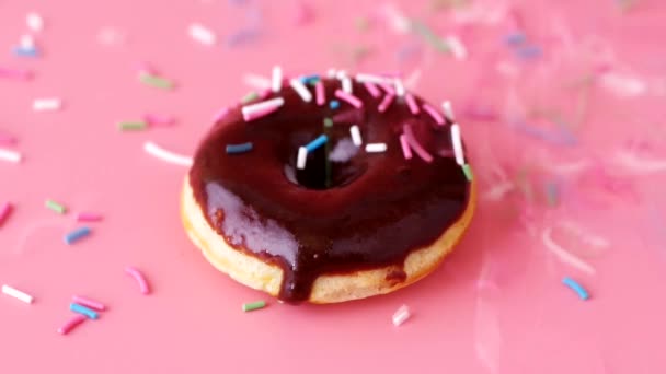 Bright Donut Chocolate Glazing Colorful Sprinkles Falling Donut Pink Background — Stock Video