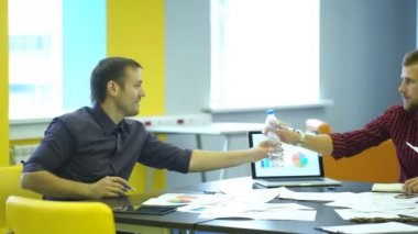 Üç iş adamları kanepede klasörleri tutarak oturan ve konuşma